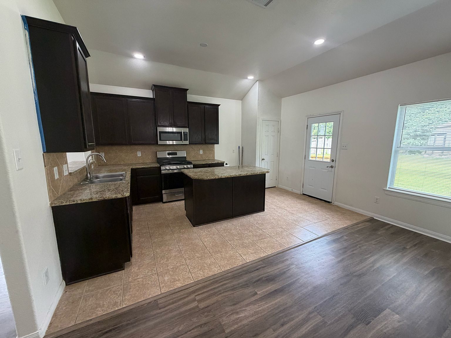 Kitchen with granite counters and island